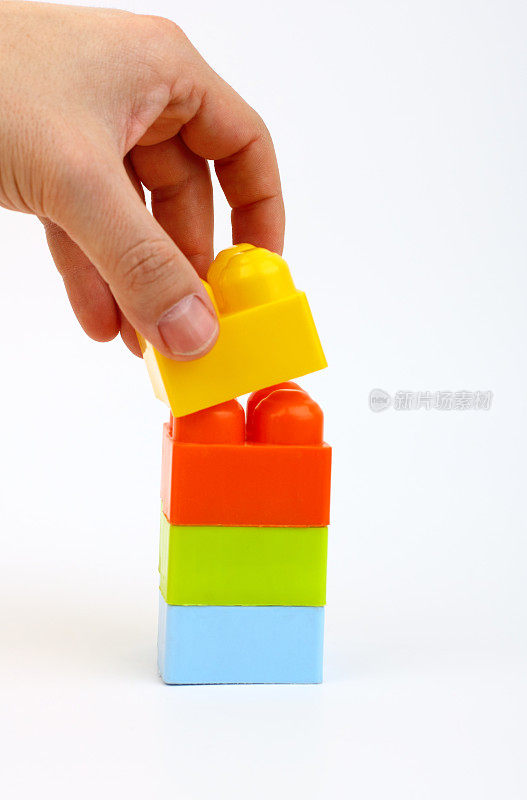 Hand is buildings with toy bricks